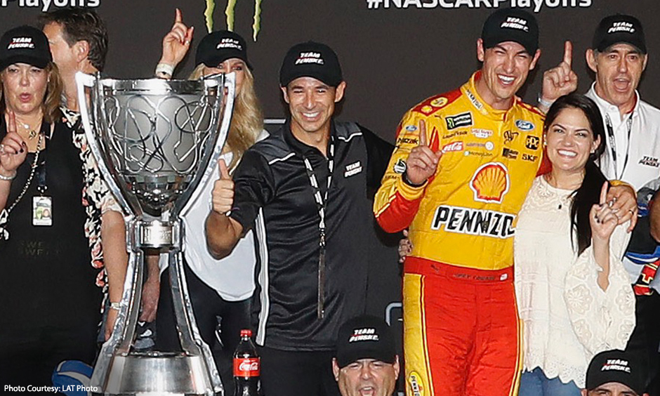 Helio Castroneves and Joey Logano celebrate after Team Penske secured the NASCAR Cup Championship.