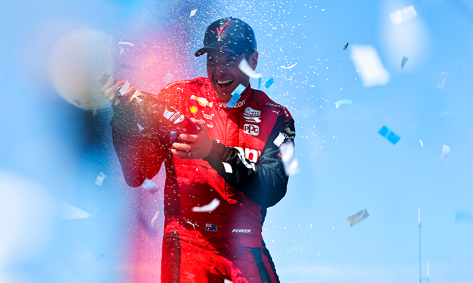 Will Power sprays champagne after winning the 2022 NTT INDYCAR SERIES Championship